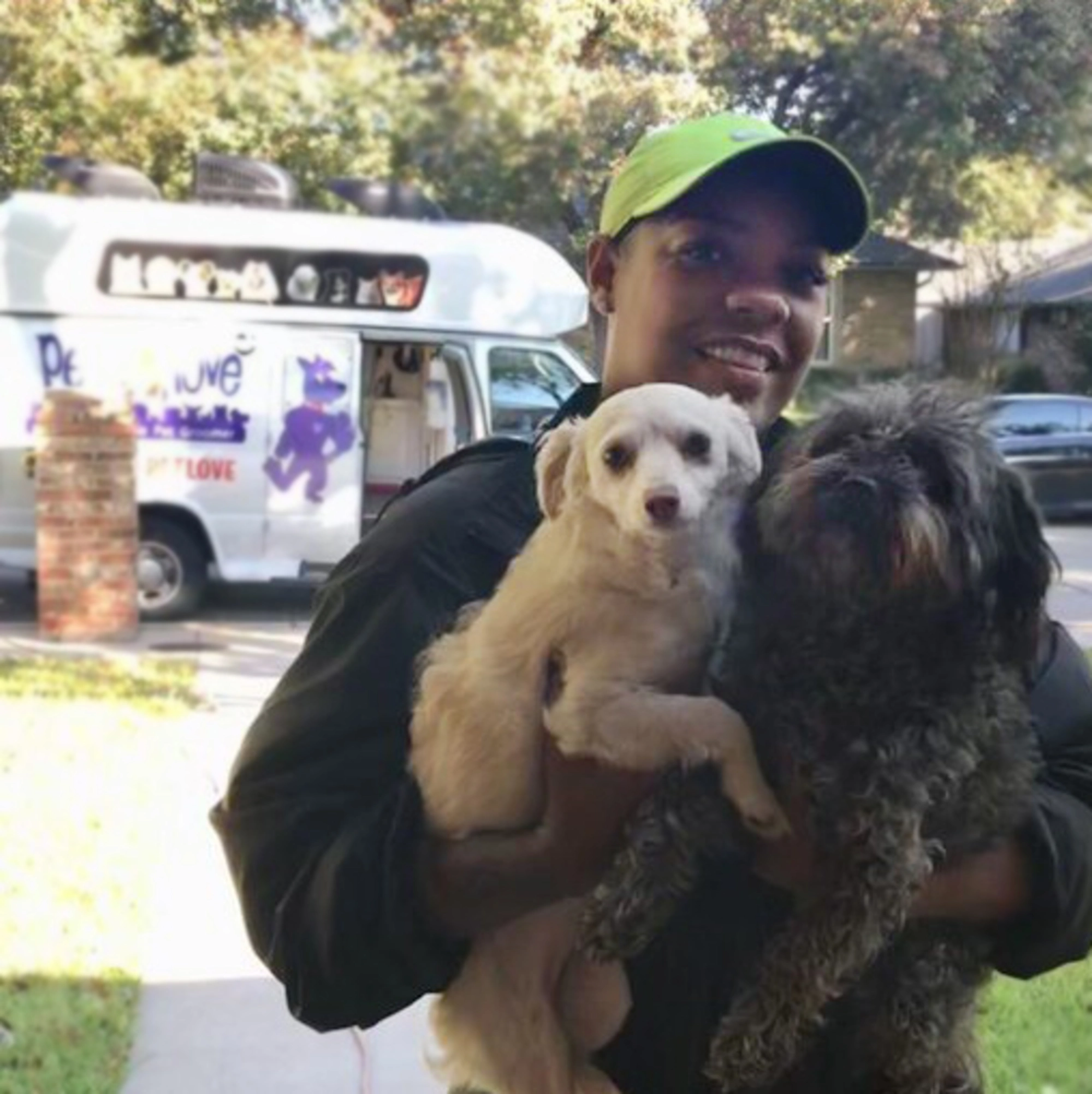 pet love groomer carrying two dogs